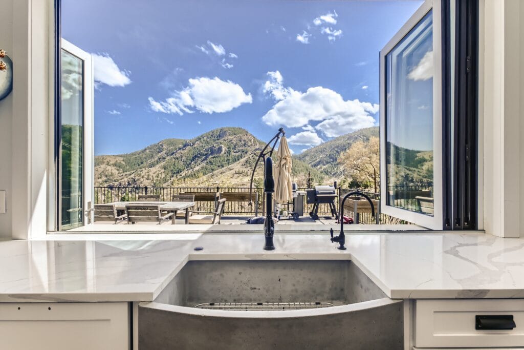 A kitchen window overlooks the mountains